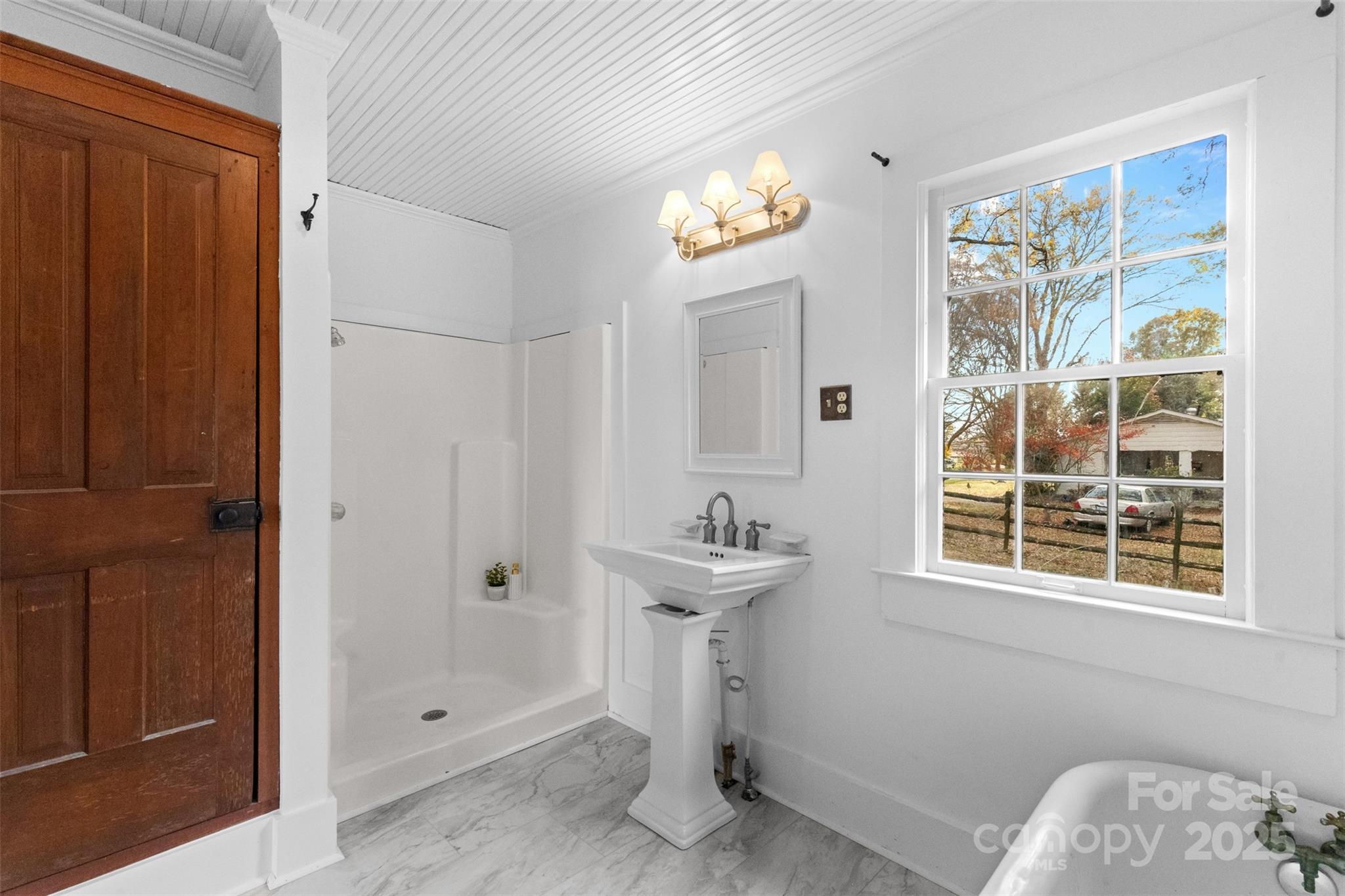 5607 Matthews-Mint Hill Road Charlotte, NC 28227 - Photo 25 of 45 a bathroom with a sink a toilet and shower