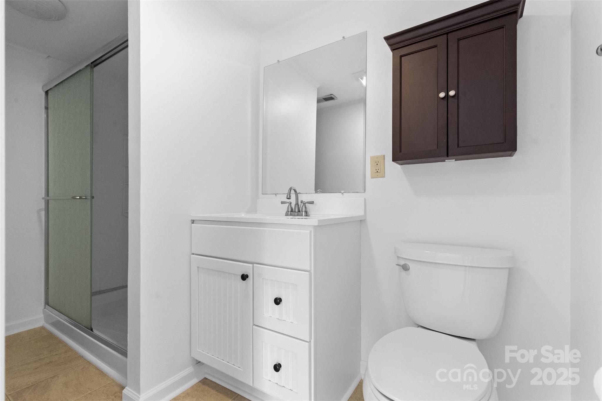 5607 Matthews-Mint Hill Road Charlotte, NC 28227 - Photo 35 of 45 a bathroom with a toilet a sink and mirror