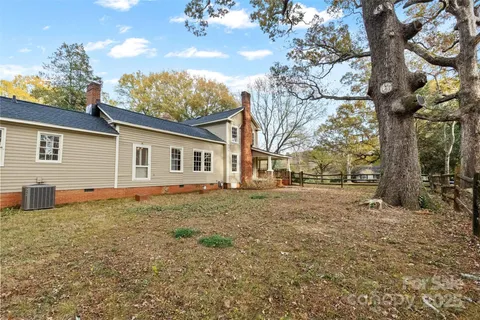 a house that has a tree in front of it