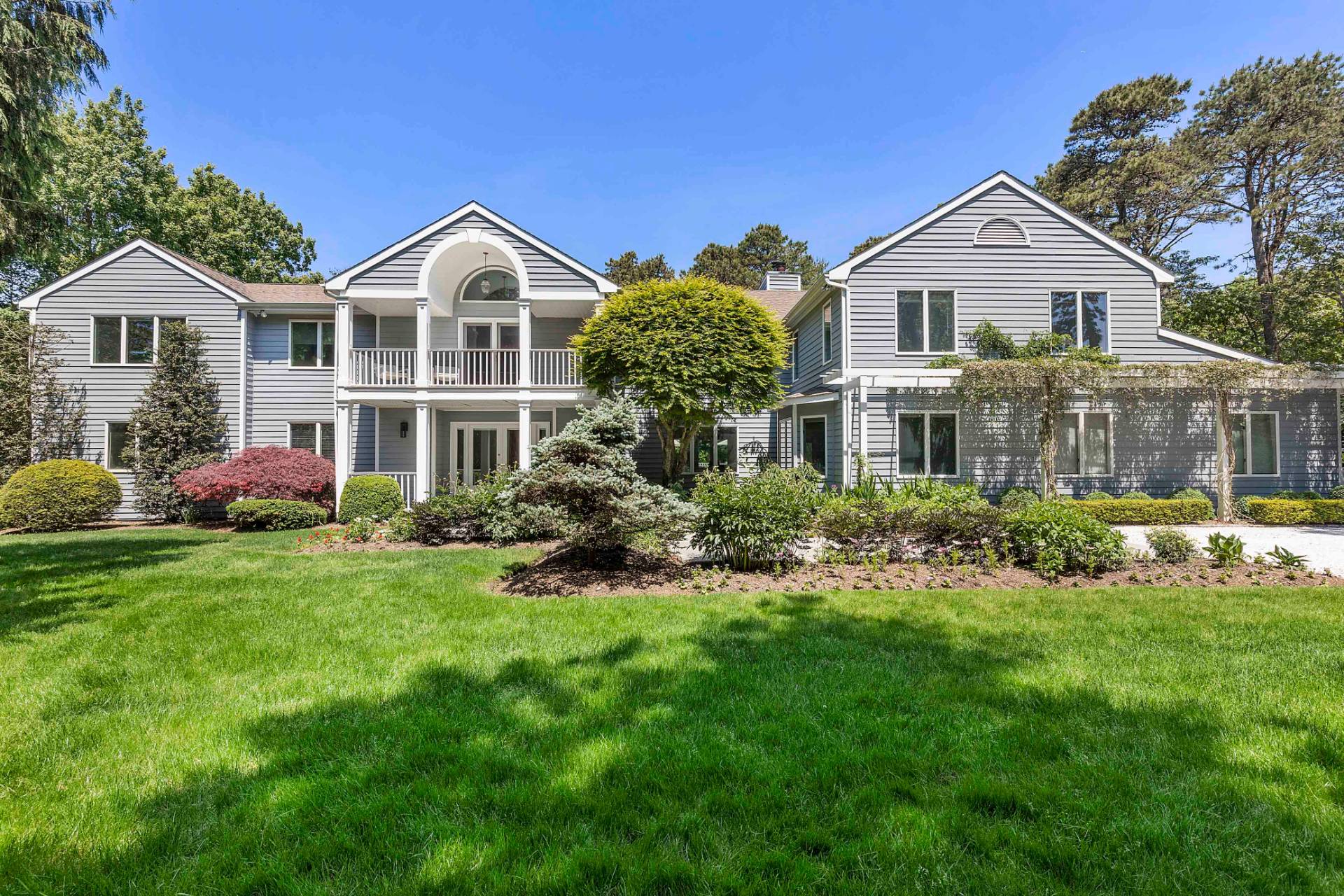 a front view of a house with a yard and porch