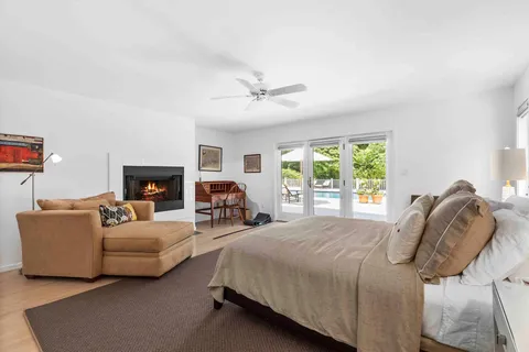 a bedroom with bed couch and window