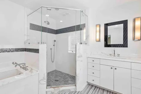 a bathroom with a tub sink and mirror