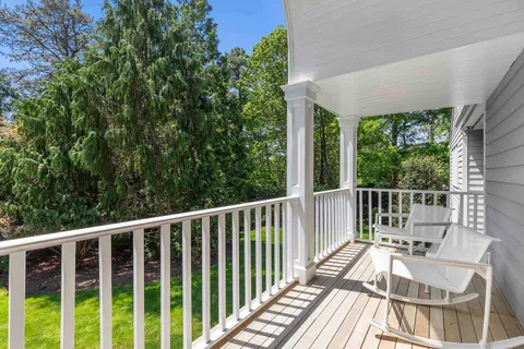 a view of balcony with wooden floor and fence