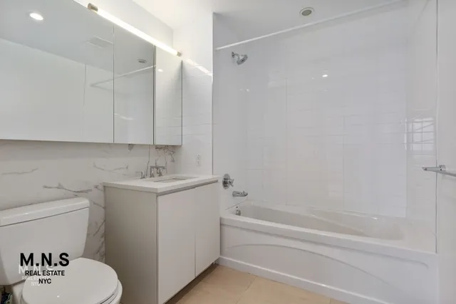 a view of a kitchen with wooden floor and electronic appliances