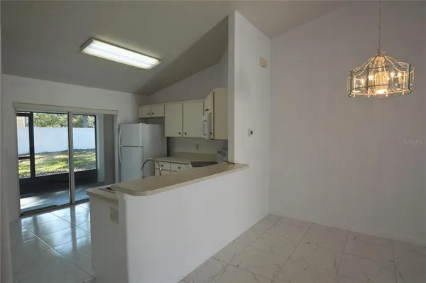 a kitchen that has a sink and a stove top oven