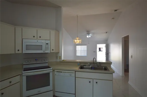 a kitchen with cabinets stainless steel appliances and a sink