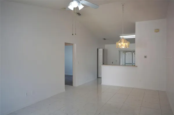 a view of a hallway with chandelier
