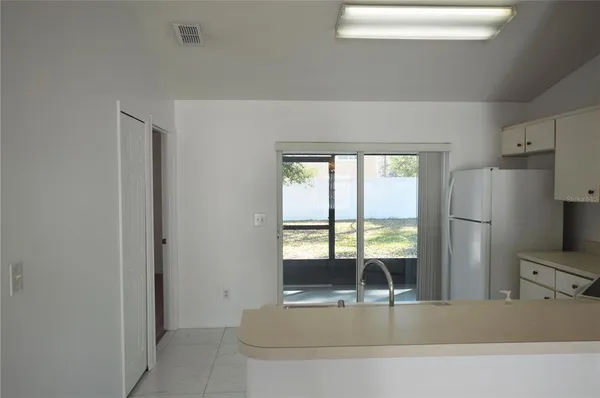 a kitchen with kitchen island a counter top space and stainless steel appliances