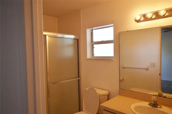 a bathroom with a sink mirror vanity and toilet