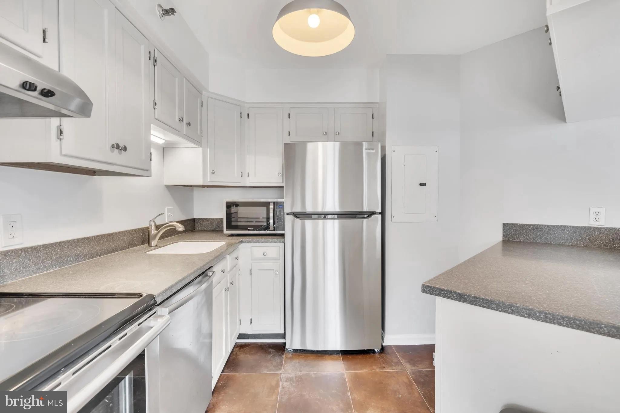 1301 North Courthouse Road, Unit 1007 Arlington, VA 22201 - Photo 12 of 41 a kitchen with a sink a refrigerator and a stove