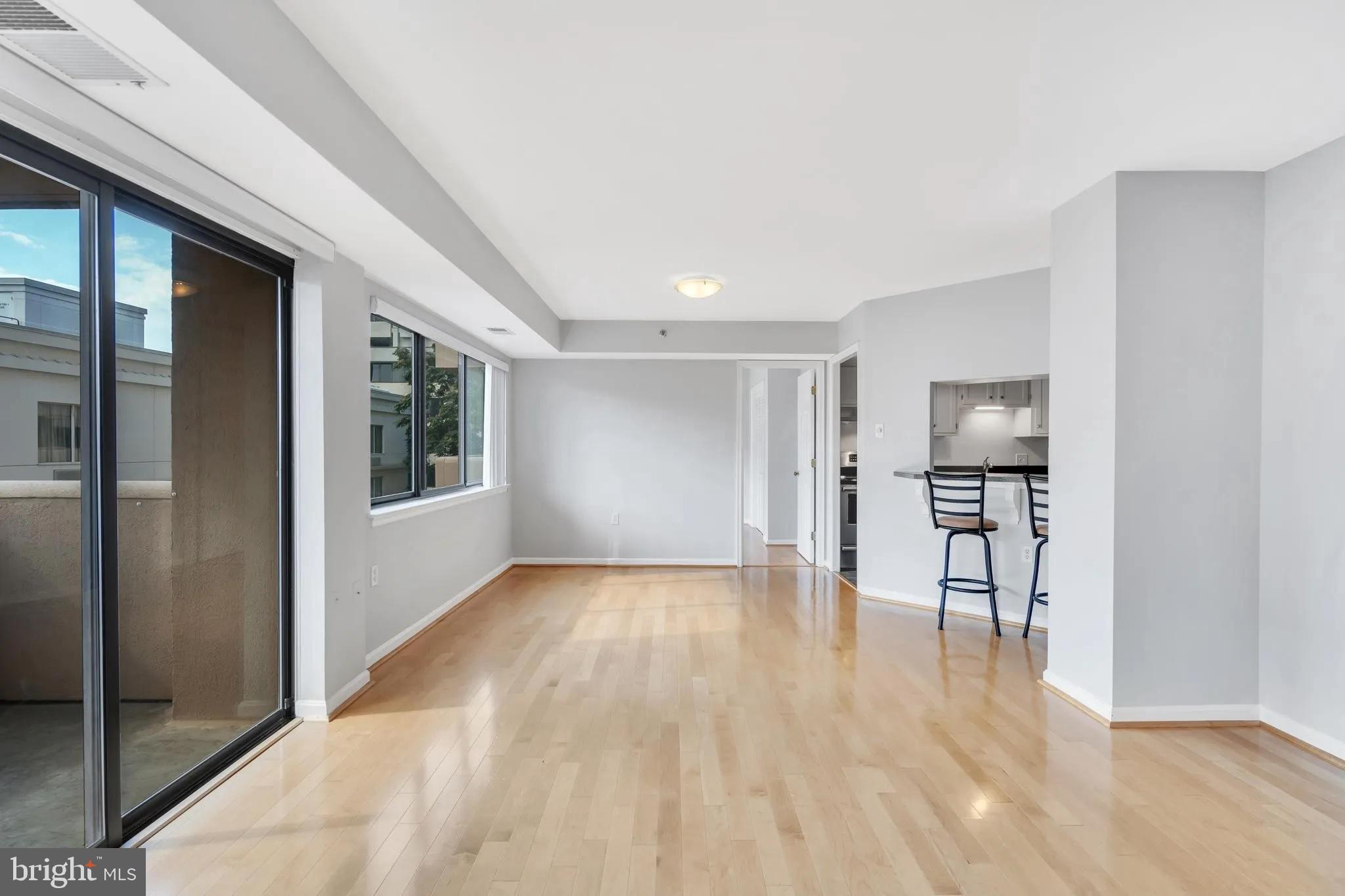 1301 North Courthouse Road, Unit 1007 Arlington, VA 22201 - Photo 15 of 41 a view of empty room with wooden floor and windows