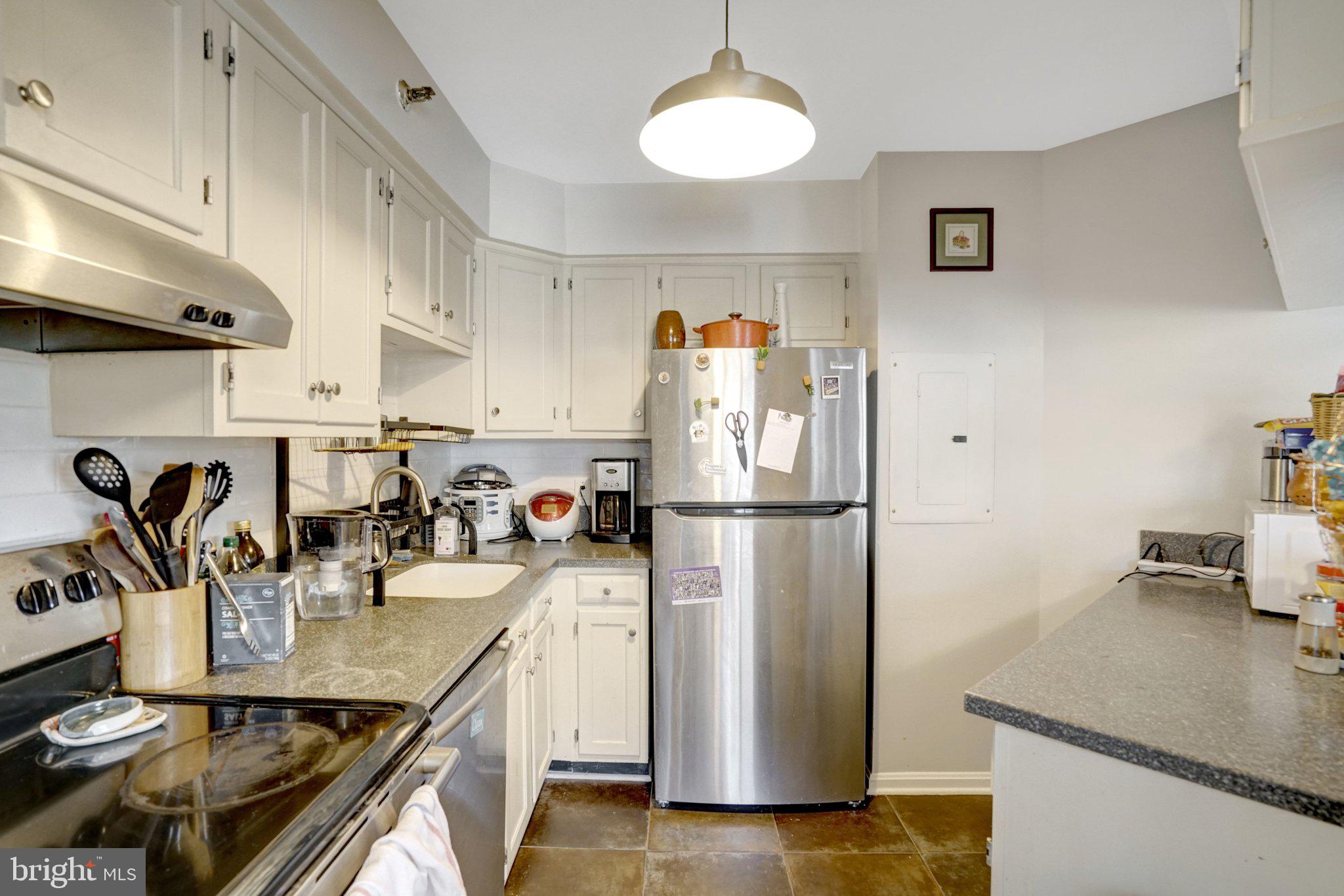 1301 North Courthouse Road, Unit 1007 Arlington, VA 22201 - Photo 26 of 41 a kitchen with refrigerator and table