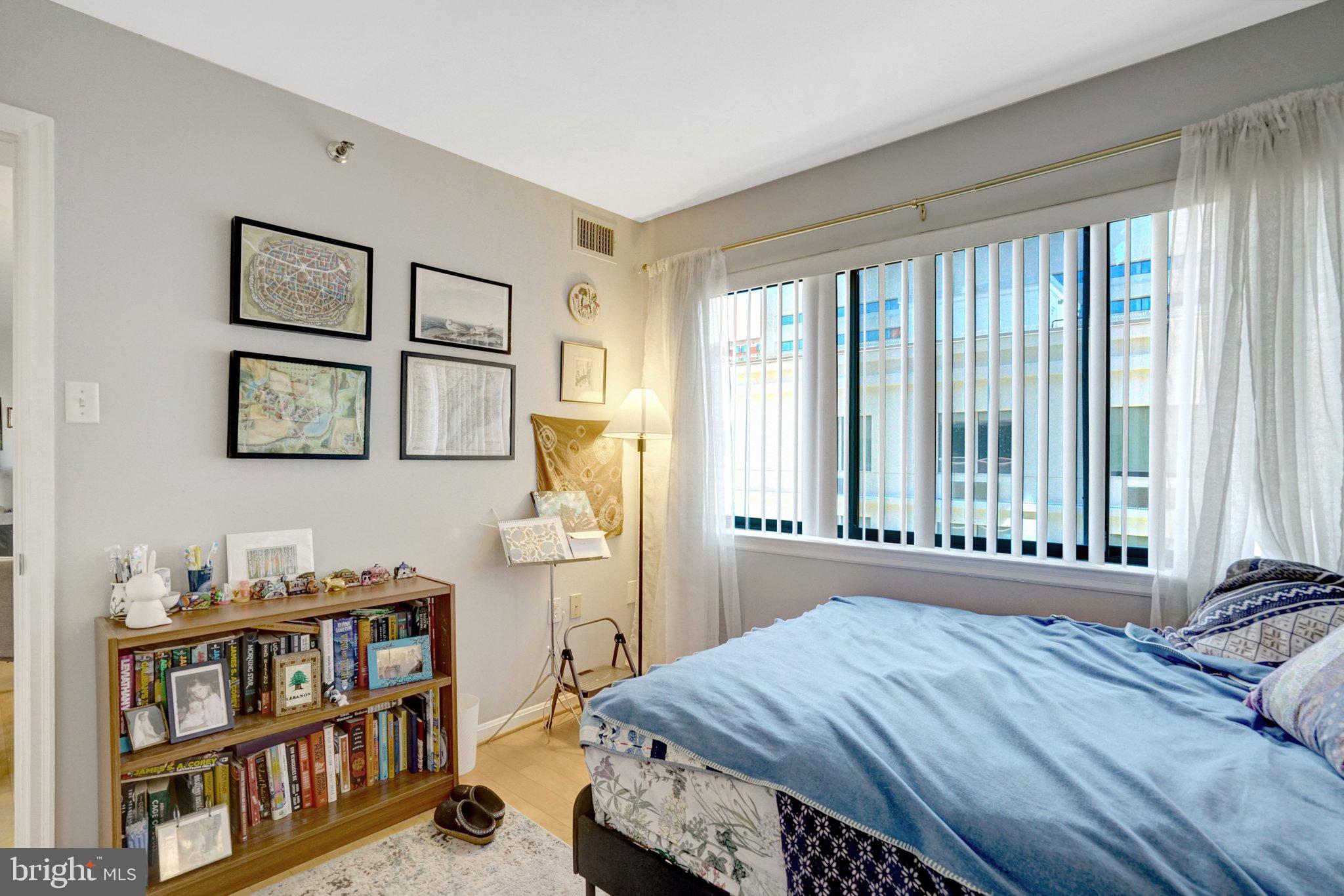 1301 North Courthouse Road, Unit 1007 Arlington, VA 22201 - Photo 28 of 41 a bed room with a bed and a window
