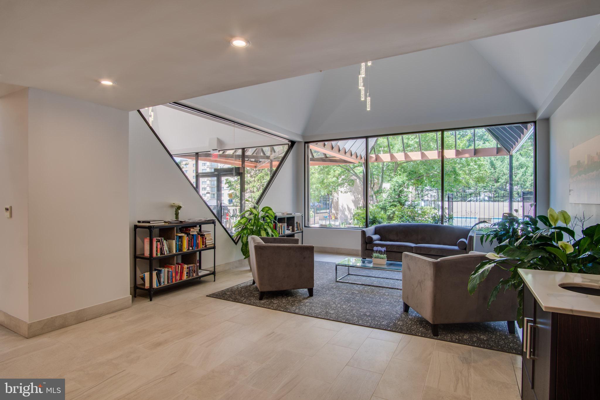 1301 North Courthouse Road, Unit 1007 Arlington, VA 22201 - Photo 31 of 41 a living room with furniture a flat screen tv and a potted plant