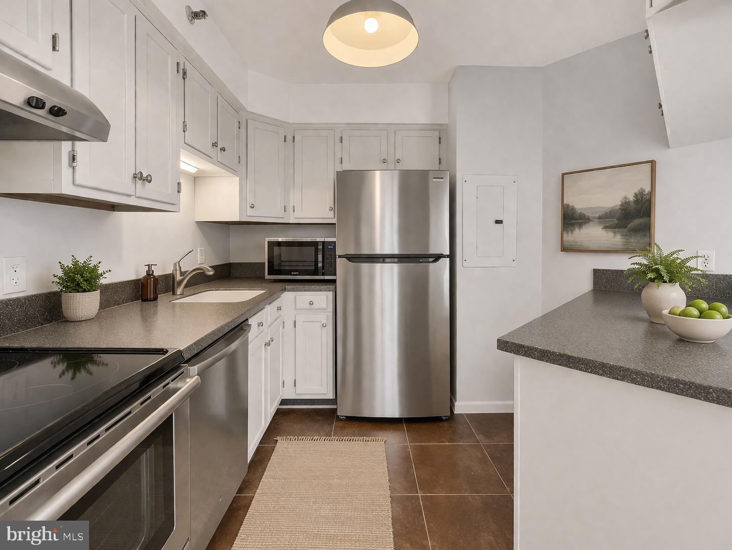 1301 North Courthouse Road, Unit 1007 Arlington, VA 22201 - Photo 4 of 41 a kitchen with stainless steel appliances granite countertop a sink a refrigerator a stove a white table and chairs