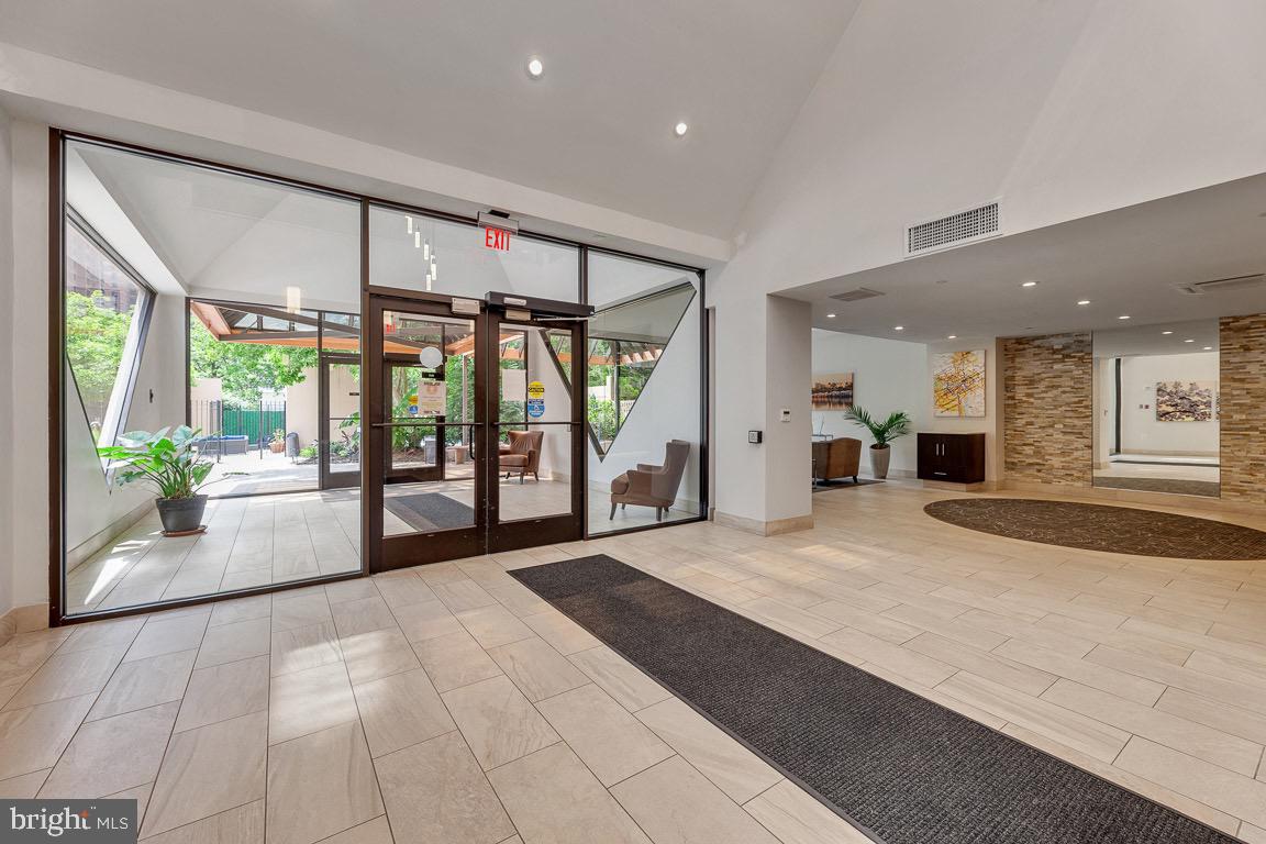 1301 North Courthouse Road, Unit 1007 Arlington, VA 22201 - Photo 40 of 41 a large white room with a large window and chandelier