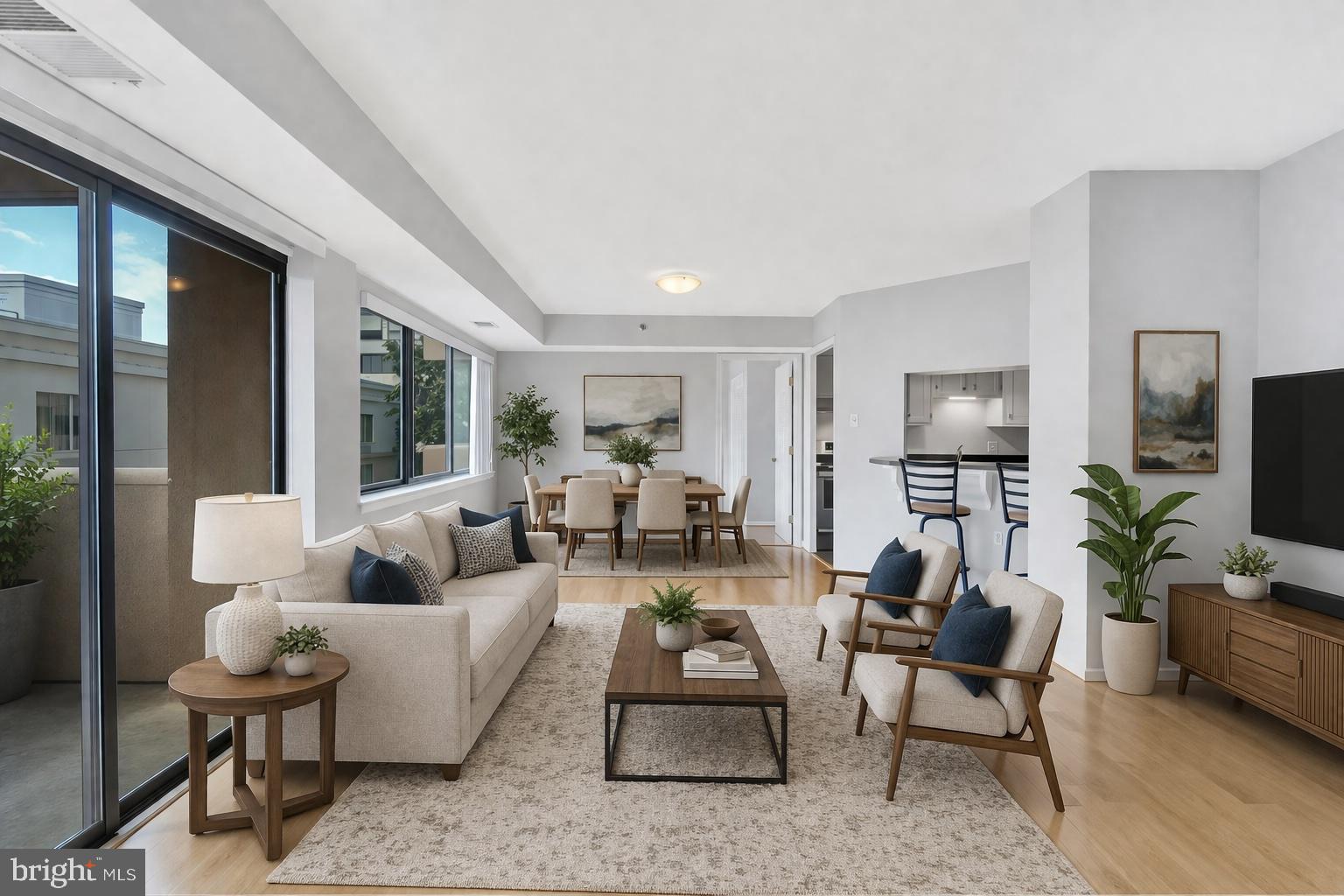1301 North Courthouse Road, Unit 1007 Arlington, VA 22201 - Photo 6 of 41 a living room with furniture potted plant and a flat screen tv