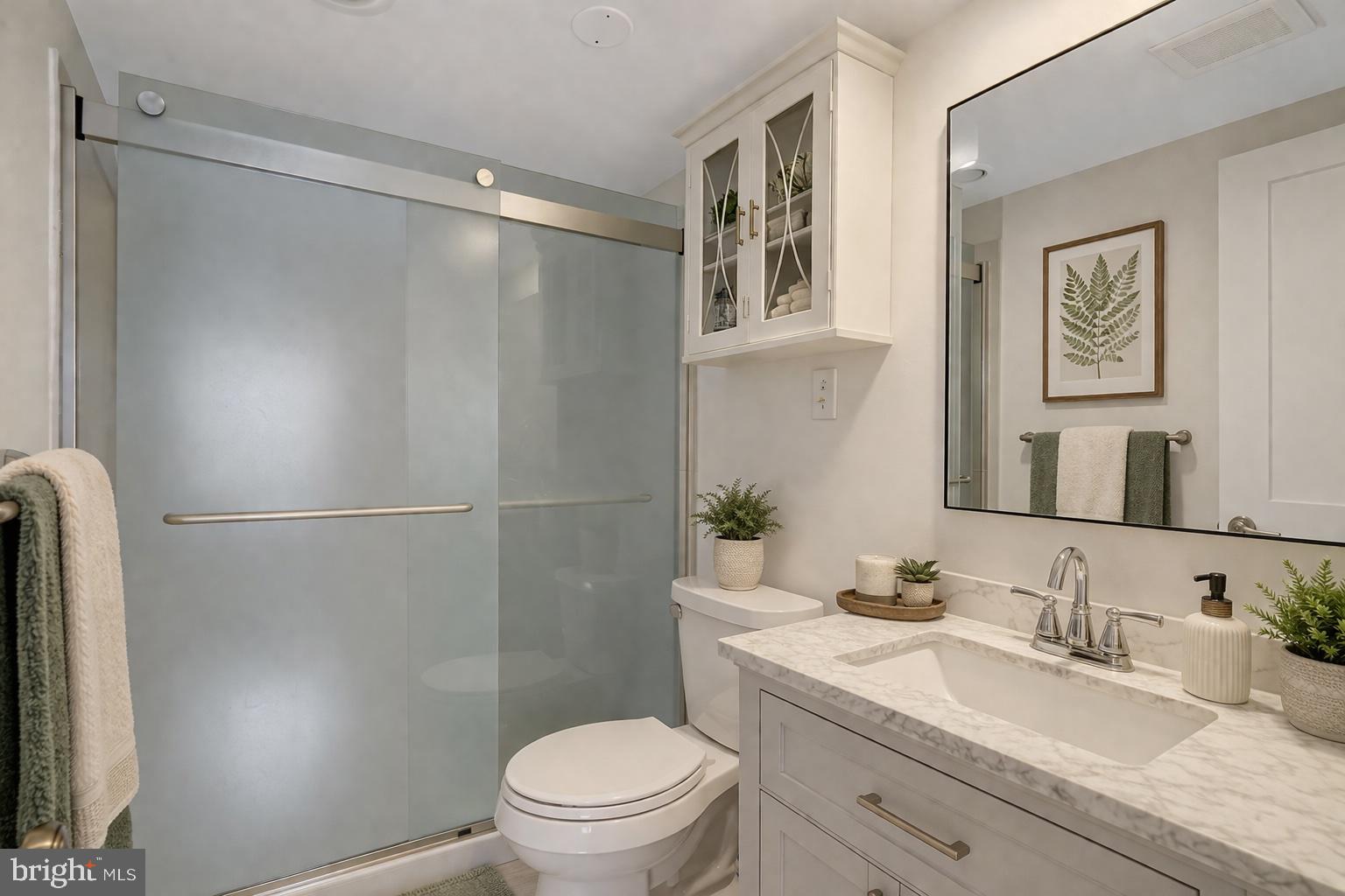1301 North Courthouse Road, Unit 1007 Arlington, VA 22201 - Photo 8 of 41 a bathroom with a granite countertop sink toilet and shower
