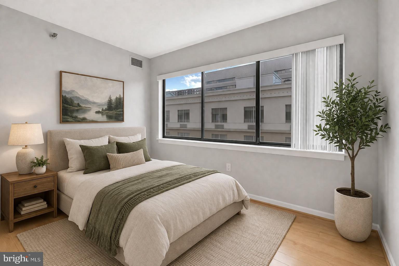 1301 North Courthouse Road, Unit 1007 Arlington, VA 22201 - Photo 9 of 41 a bedroom with a bed and a potted plant