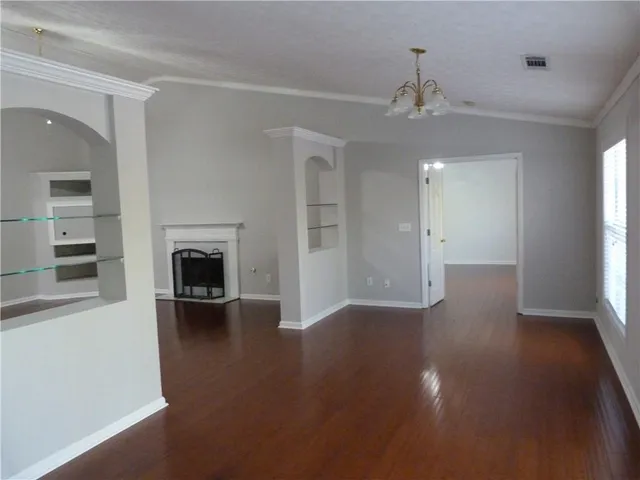 wooden floor in an empty room with a fireplace