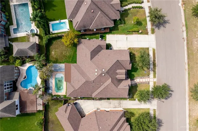 an aerial view of a house with a yard