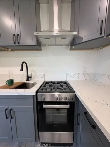 a kitchen with granite countertop cabinets stainless steel appliances and wooden cabinets