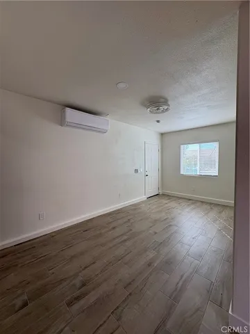 a view of a room with wooden floor and window