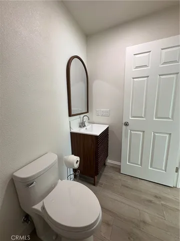 a bathroom with a toilet a sink and mirror
