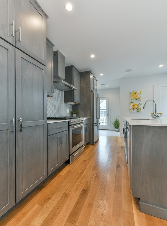 38 Edwin Street, Unit 2 Boston, MA 02124 - Photo 11 of 22 a kitchen with stainless steel appliances a refrigerator and a sink