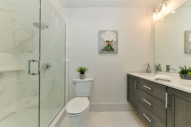 a bathroom with a toilet a sink and shower