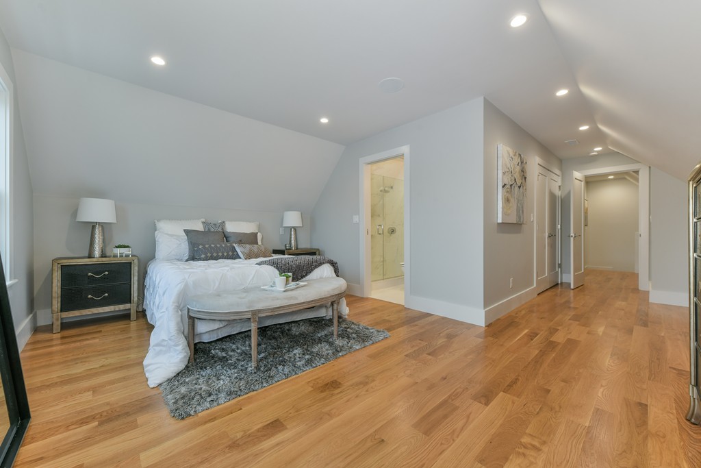 38 Edwin Street, Unit 2 Boston, MA 02124 - Photo 19 of 22 a bedroom with a bed and wooden floor