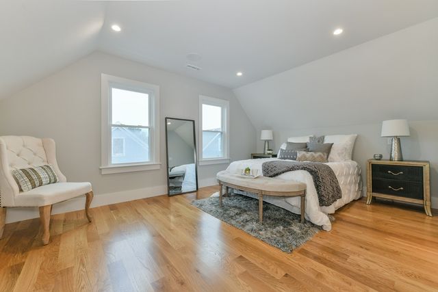 a bedroom with a bed and a chair