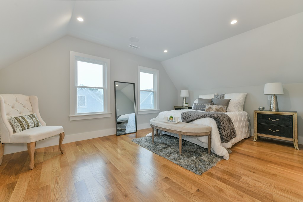 38 Edwin Street, Unit 2 Boston, MA 02124 - Photo 20 of 22 a bedroom with a bed and a chair