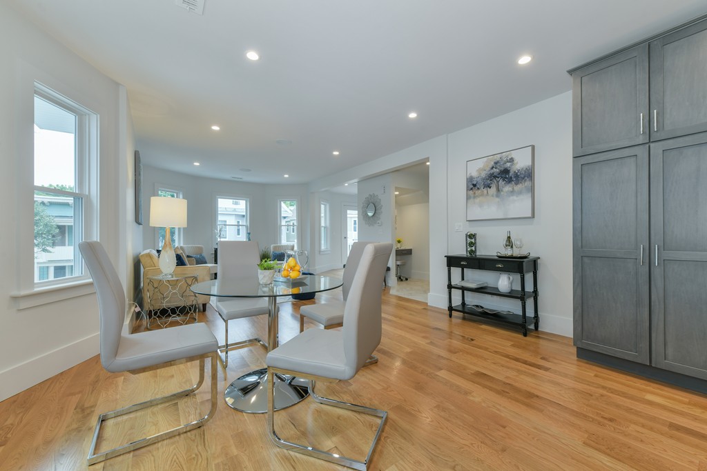 38 Edwin Street, Unit 2 Boston, MA 02124 - Photo 3 of 22 a living room with furniture a dining table and chairs next to a window