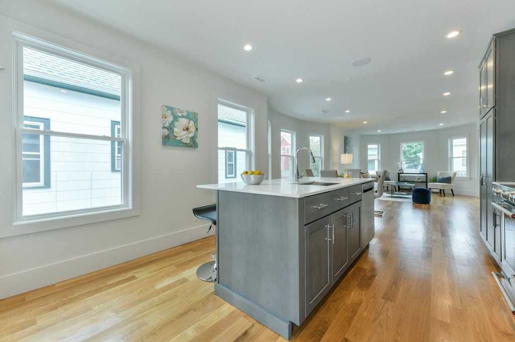 38 Edwin Street, Unit 2 Boston, MA 02124 - Photo 8 of 22 a large kitchen with stainless steel appliances granite countertop a large counter top a stove and a window