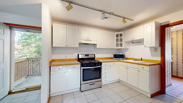 a kitchen with a stove a sink and a refrigerator