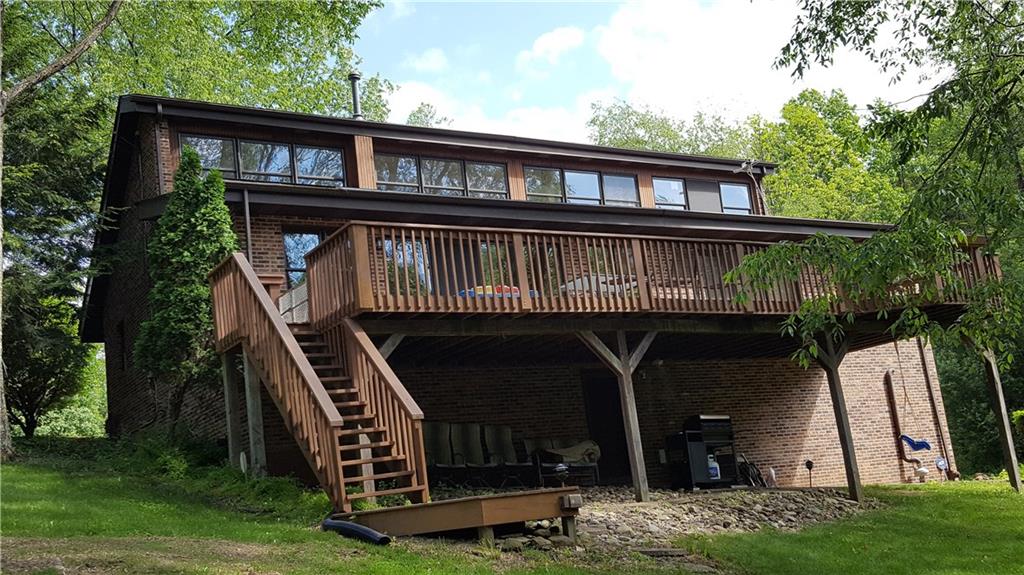 3636 Sandy Hill Road Gibsonia, PA 15044 - Photo 2 of 25 Back of House: Wall of windows line the back of the upstairs allowing for plenty of natural lightening. Oversize deck the length of the house is awesome to entertain or just sit back and enjoy the nature in your back yard.