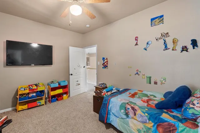 a bedroom with toys and a flat screen tv