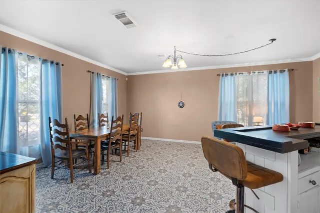 a dining room with furniture and window