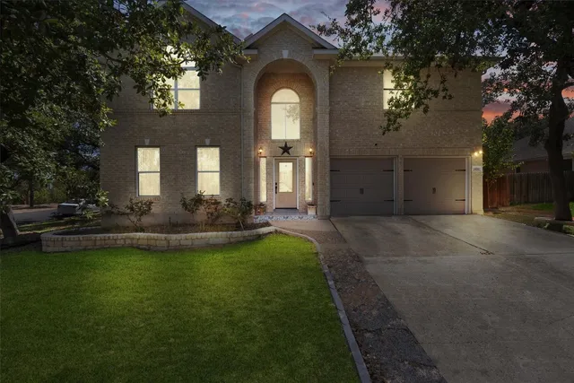 a front view of a house with a garden