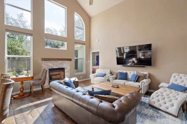 a living room with furniture fireplace and a flat screen tv