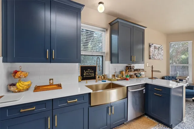 a kitchen with stainless steel appliances granite countertop a sink stove and cabinets