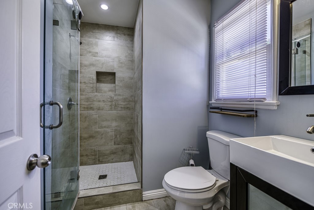 15744 Hart Street Van Nuys, CA 91406 - Photo 12 of 21 a bathroom with a sink a toilet and shower
