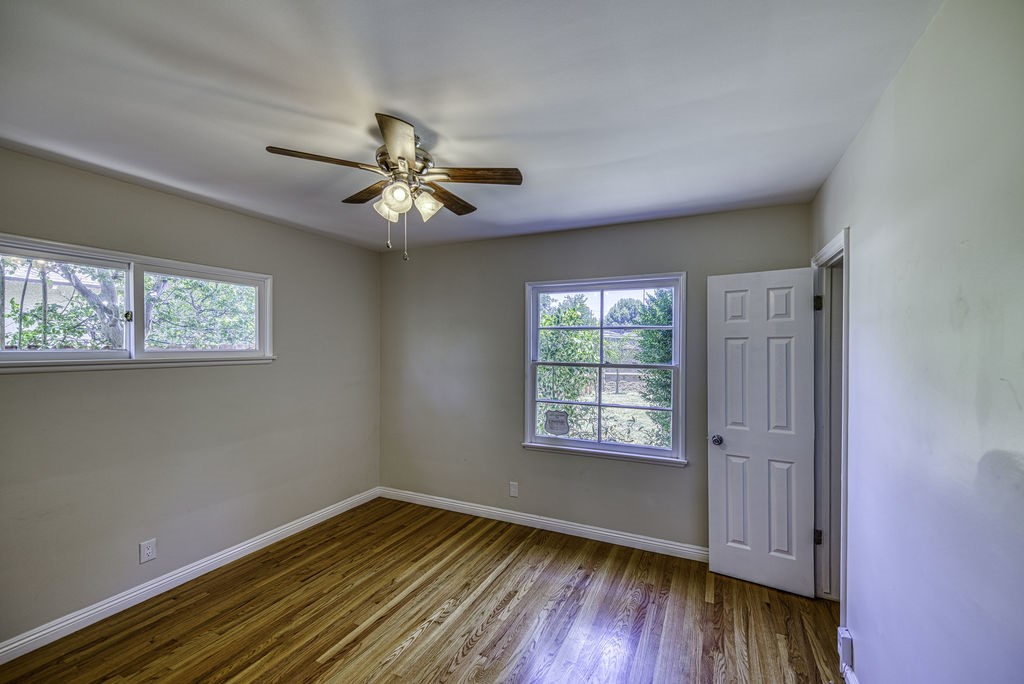 15744 Hart Street Van Nuys, CA 91406 - Photo 14 of 21 a view of empty room with wooden floor and fan