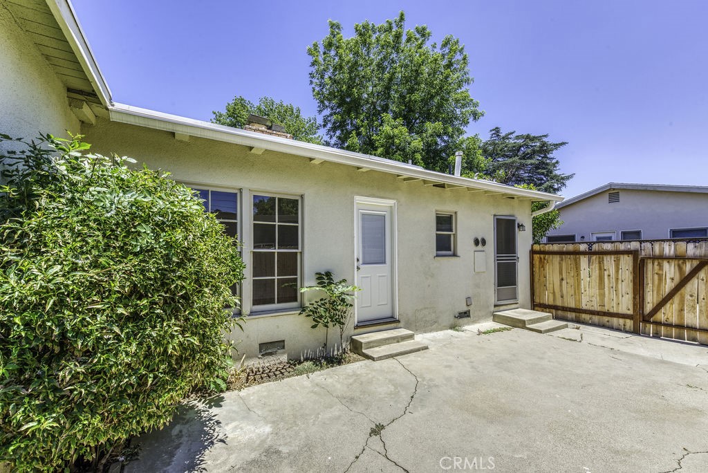 15744 Hart Street Van Nuys, CA 91406 - Photo 19 of 21 a front view of a house with a yard and potted plants