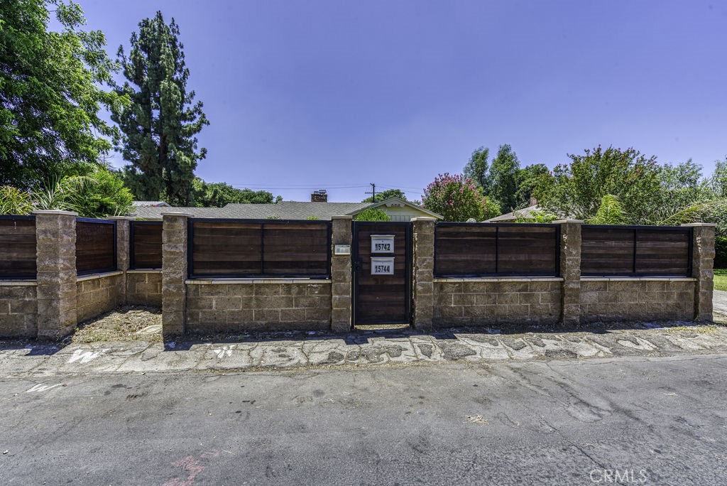 15744 Hart Street Van Nuys, CA 91406 - Photo 21 of 21 a front view of a house with a yard and garage
