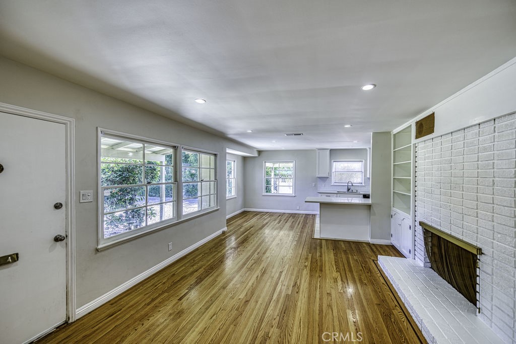 15744 Hart Street Van Nuys, CA 91406 - Photo 4 of 21 a view of a living room with a large window and wooden floor