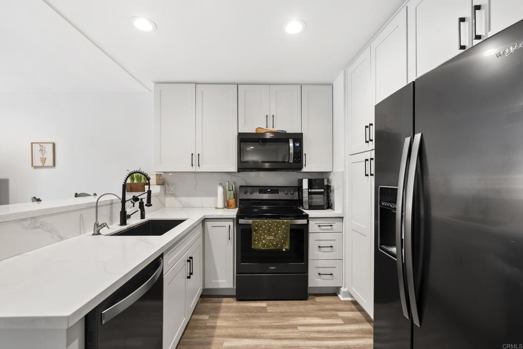 6780 Friars Road, Unit 243 San Diego, CA 92108 - Photo 1 of 31 a kitchen with stainless steel appliances a refrigerator a stove and a sink