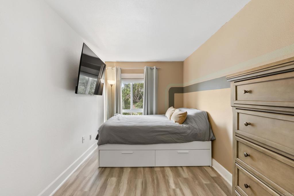 6780 Friars Road, Unit 243 San Diego, CA 92108 - Photo 17 of 31 a bedroom with a bed and a flat screen tv