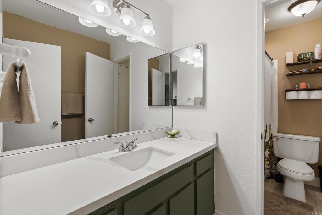 6780 Friars Road, Unit 243 San Diego, CA 92108 - Photo 20 of 31 a bathroom with a sink a toilet and a mirror